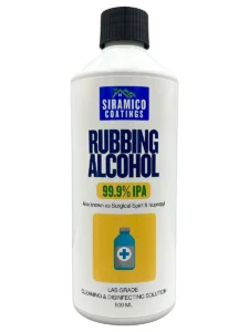 Rubbing alcohol bottle with a cotton pad on a clean surface